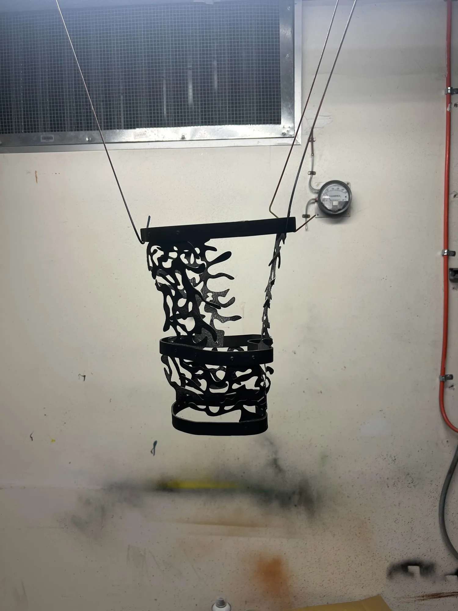 The assembled lamp suspended on supports for spray finishing.