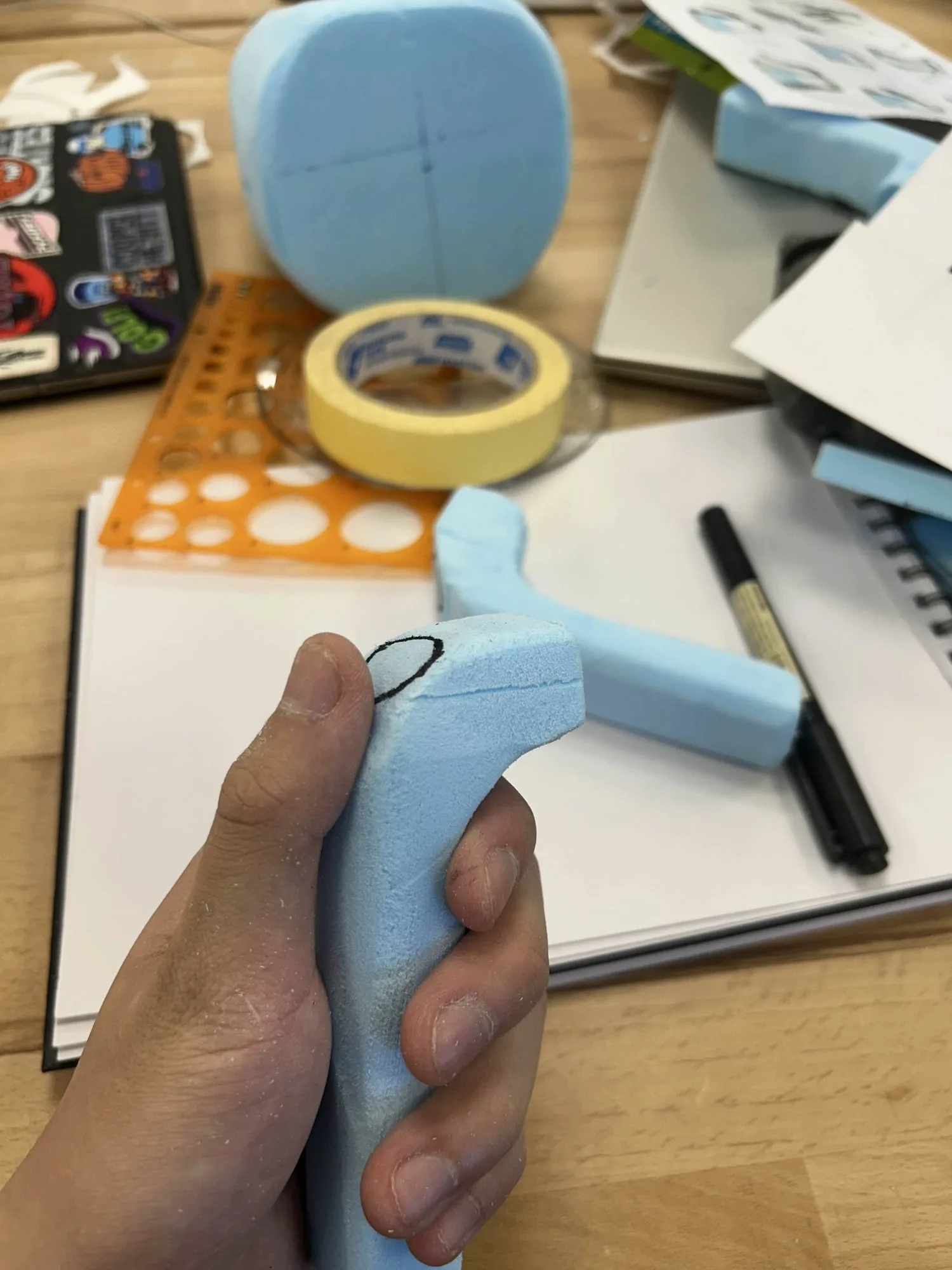 A foam handle mock-up being held to test grip.