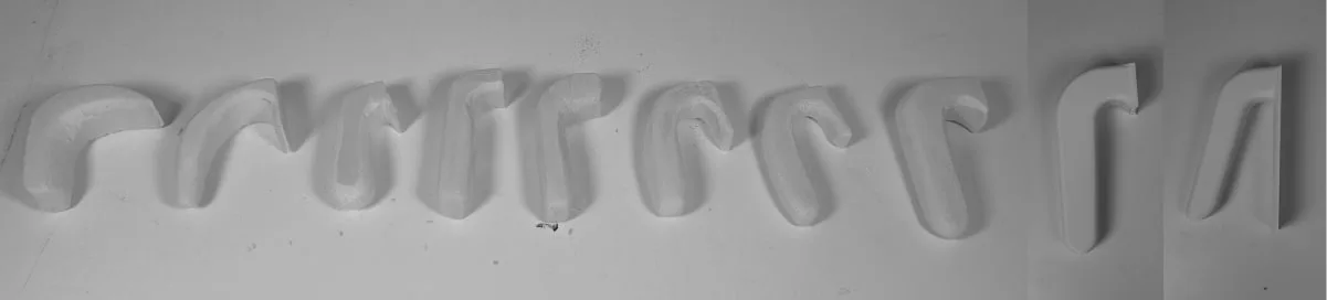 Ten handle profiles carved in foam, laid out in a row for comparison.